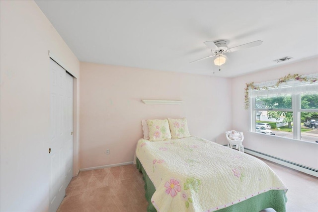2 Moor Ln, East Patchogue, NY 11772 - bedroom with carpet, baseboards, a closet, a baseboard radiator, and a ceiling fan