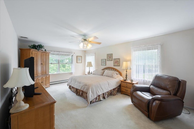 2 Moor Ln, East Patchogue, NY 11772 - bedroom with light colored carpet, baseboard heating, and ceiling fan