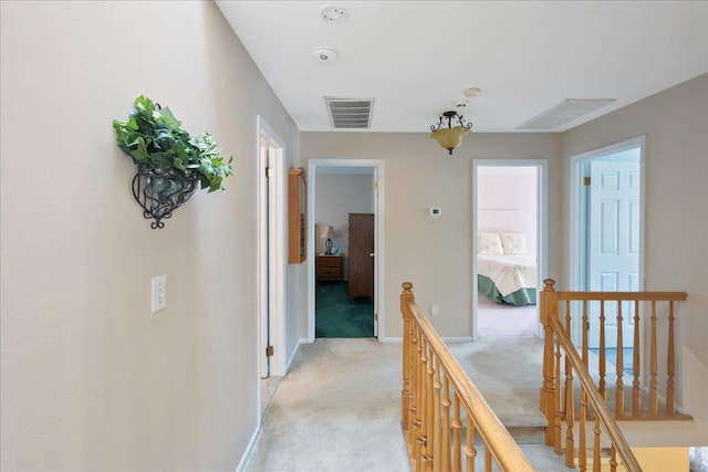 2 Moor Ln, East Patchogue, NY 11772 - hall with an upstairs landing, light colored carpet, and baseboards