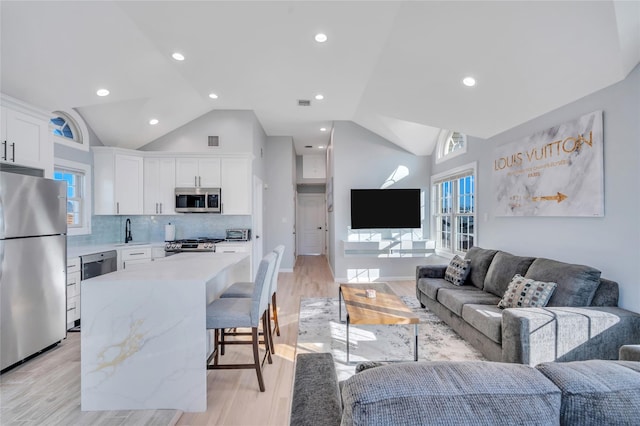 68 Brookline Ave, East Atlantic Beach, NY 11561 - living room with vaulted ceiling, plenty of natural light, light wood-style flooring, and recessed lighting