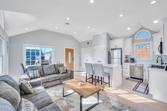 68 Brookline Ave, East Atlantic Beach, NY 11561 - living area with lofted ceiling, light wood finished floors, plenty of natural light, and recessed lighting