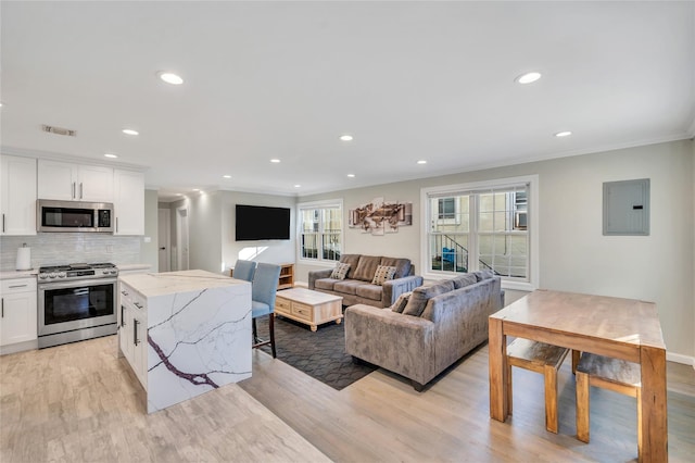 68 Brookline Ave, East Atlantic Beach, NY 11561 - living area with electric panel, ornamental molding, healthy amount of natural light, light wood-type flooring, and recessed lighting