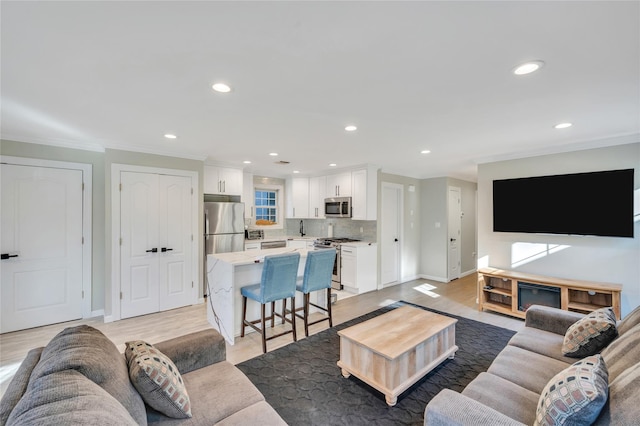 68 Brookline Ave, East Atlantic Beach, NY 11561 - living area with ornamental molding, recessed lighting, light wood-style floors, and baseboards