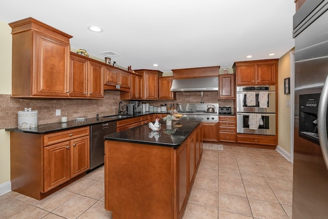1450 Tadmor St, Merrick, NY 11566 - kitchen featuring stainless steel appliances, ventilation hood, light tile patterned floors, brown cabinets, and decorative backsplash