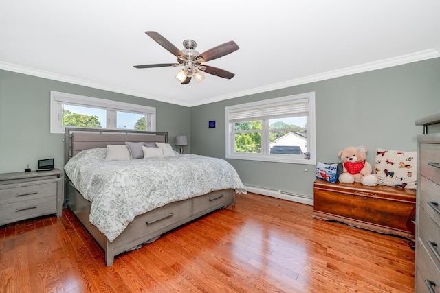 1450 Tadmor St, Merrick, NY 11566 - bedroom featuring baseboard heating, ornamental molding, light wood-style floors, baseboards, and ceiling fan