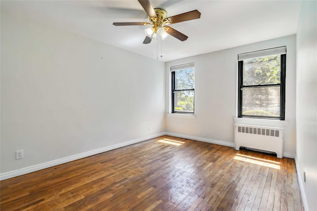 22-39 78th St Unit 2F, East Elmhurst, NY 11370 - spare room with radiator, hardwood / wood-style flooring, ceiling fan, and baseboards