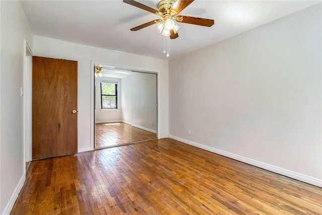22-39 78th St Unit 2F, East Elmhurst, NY 11370 - unfurnished bedroom featuring wood-type flooring, a closet, baseboards, and a ceiling fan