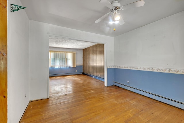 34 Leeside Dr, Carmel, NY 10512 - spare room with a baseboard radiator, wood finished floors, a ceiling fan, and a baseboard heating unit