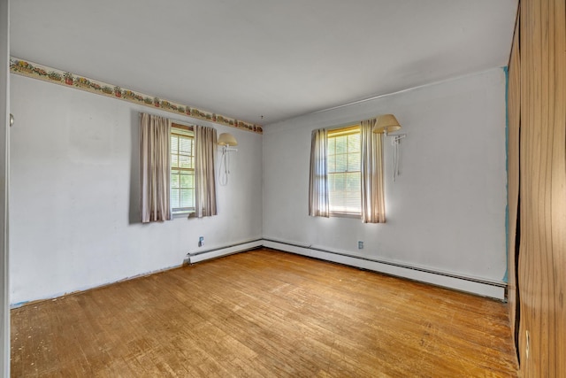 34 Leeside Dr, Carmel, NY 10512 - spare room with healthy amount of natural light, wood finished floors, and baseboard heating