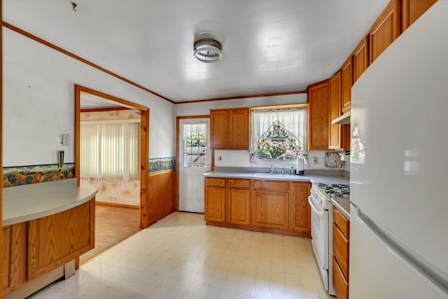 34 Leeside Dr, Carmel, NY 10512 - kitchen with white appliances, light flooring, a wainscoted wall, light countertops, and brown cabinetry