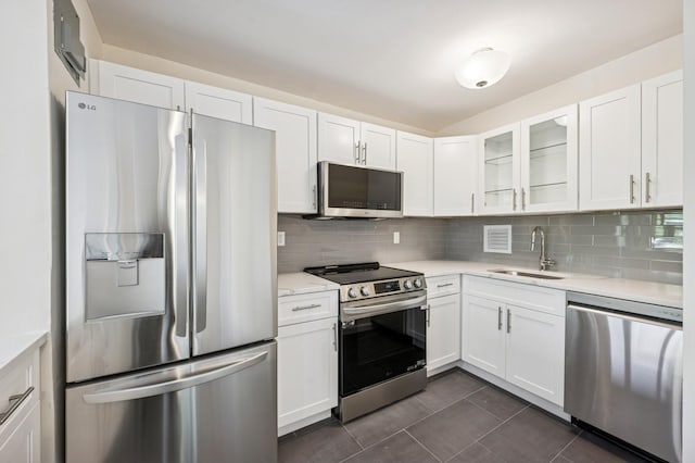 10-11 162nd St Unit 4A, Beechhurst, NY 11357 - kitchen featuring appliances with stainless steel finishes, a sink, white cabinetry, decorative backsplash, and glass insert cabinets