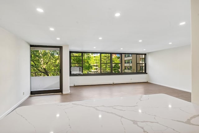 10-11 162nd St Unit 4A, Beechhurst, NY 11357 - spare room featuring recessed lighting, baseboards, wood finished floors, and cooling unit