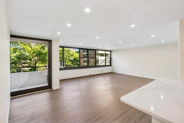 10-11 162nd St Unit 4A, Beechhurst, NY 11357 - unfurnished living room with recessed lighting, wood finished floors, and baseboards