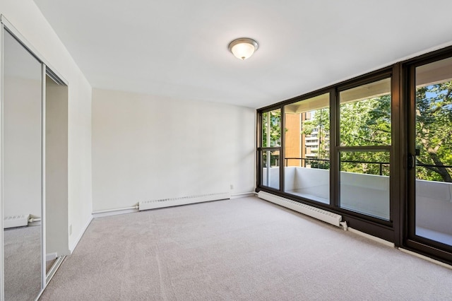 10-11 162nd St Unit 4A, Beechhurst, NY 11357 - carpeted spare room featuring a baseboard radiator, plenty of natural light, a baseboard heating unit, and baseboards