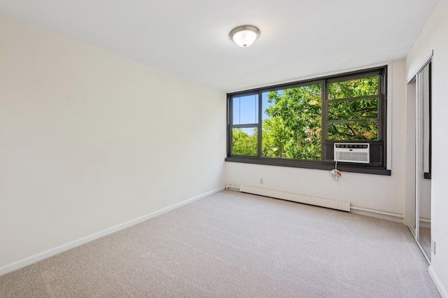 10-11 162nd St Unit 4A, Beechhurst, NY 11357 - spare room featuring a baseboard heating unit, carpet, and baseboards