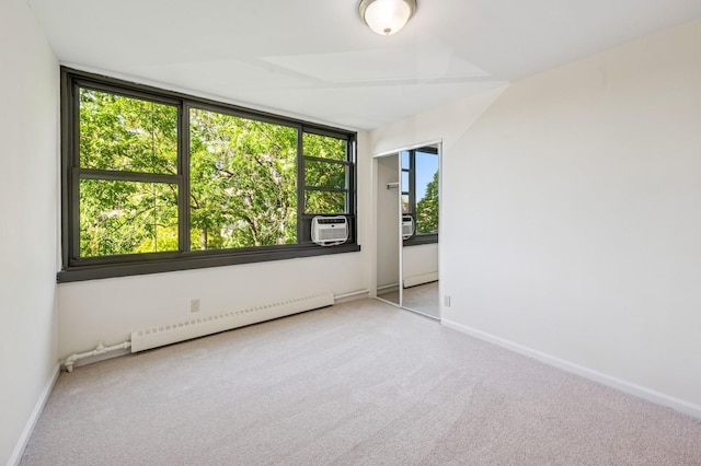 10-11 162nd St Unit 4A, Beechhurst, NY 11357 - carpeted empty room featuring a baseboard radiator, baseboards, and cooling unit