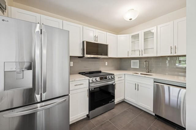 10-11 162nd St Unit 4A, Beechhurst, NY 11357 - kitchen featuring stainless steel appliances, a sink, white cabinetry, and decorative backsplash