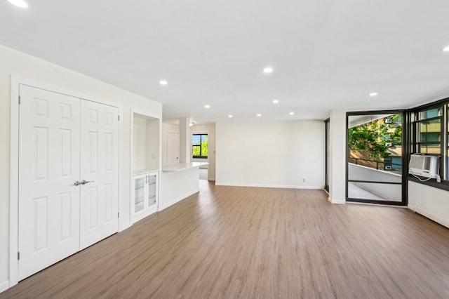 10-11 162nd St Unit 4A, Beechhurst, NY 11357 - unfurnished living room with light wood-type flooring, baseboards, and recessed lighting