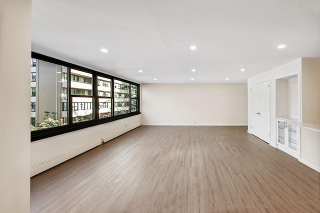 10-11 162nd St Unit 4A, Beechhurst, NY 11357 - empty room featuring wood finished floors, recessed lighting, and baseboards
