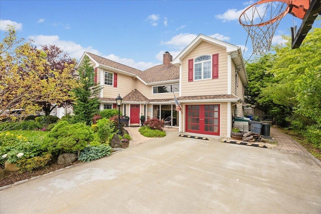 10 Bulaire, East Rockaway, NY 11518 - view of front of house with a chimney and french doors