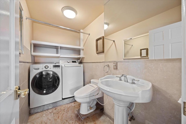 10 Bulaire, East Rockaway, NY 11518 - bathroom with independent washer and dryer, tile walls, a shower, toilet, and a wainscoted wall