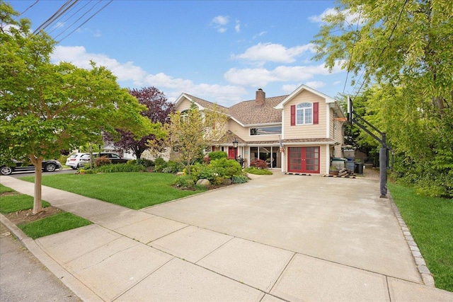 10 Bulaire, East Rockaway, NY 11518 - view of front of property featuring a chimney, a front lawn, and concrete driveway