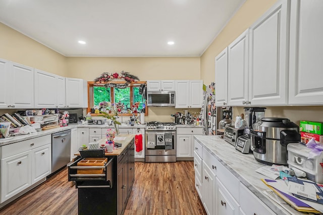 1817 Lincoln Ave, Holbrook, NY 11741 - kitchen featuring stainless steel appliances, white cabinets, wood finished floors, recessed lighting, and light stone counters