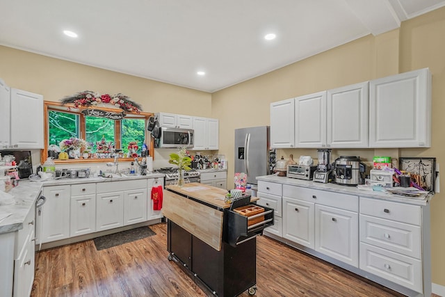 1817 Lincoln Ave, Holbrook, NY 11741 - kitchen featuring stainless steel appliances, light countertops, light wood-type flooring, white cabinets, and recessed lighting