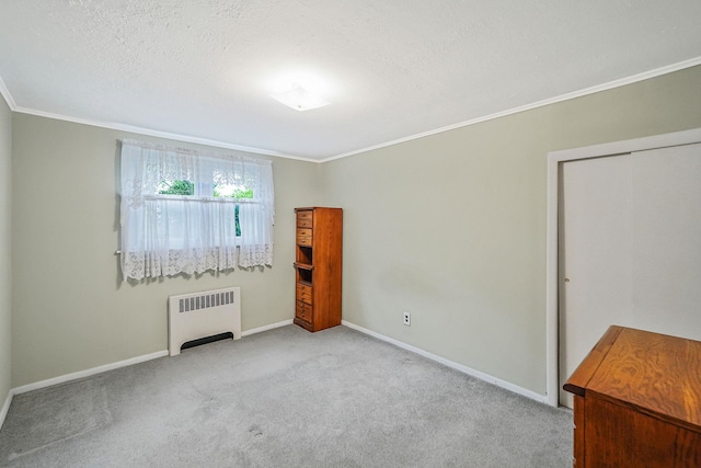 1817 Lincoln Ave, Holbrook, NY 11741 - unfurnished bedroom featuring radiator, ornamental molding, carpet flooring, and a textured ceiling