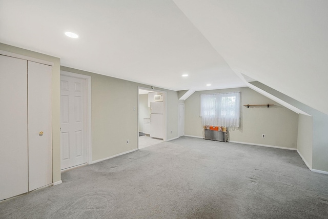 1817 Lincoln Ave, Holbrook, NY 11741 - below grade area featuring freestanding refrigerator, carpet floors, recessed lighting, and radiator
