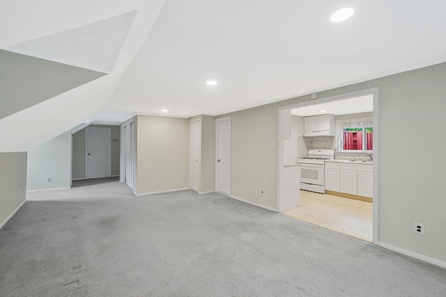 1817 Lincoln Ave, Holbrook, NY 11741 - unfurnished living room featuring recessed lighting, light carpet, and vaulted ceiling