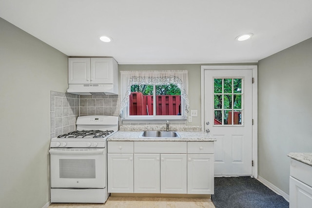 1817 Lincoln Ave, Holbrook, NY 11741 - kitchen with white gas range oven, under cabinet range hood, white cabinetry, decorative backsplash, and recessed lighting