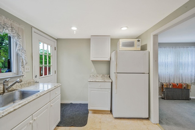 1817 Lincoln Ave, Holbrook, NY 11741 - kitchen with white appliances, radiator heating unit, light countertops, and white cabinetry