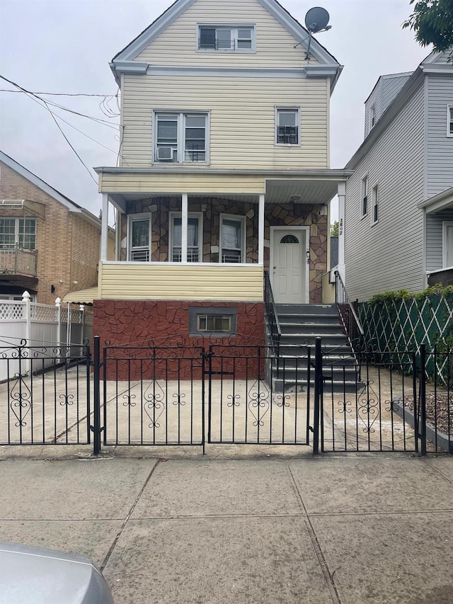 1602 Tillotson Ave, Bronx, NY 10469 - view of front of property with a fenced front yard, covered porch, and stone siding