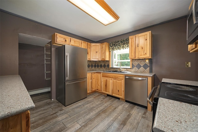 13 Cedar Ln, Poughkeepsie, NY 12601 - kitchen with appliances with stainless steel finishes, a baseboard radiator, wood finished floors, decorative backsplash, and light brown cabinetry