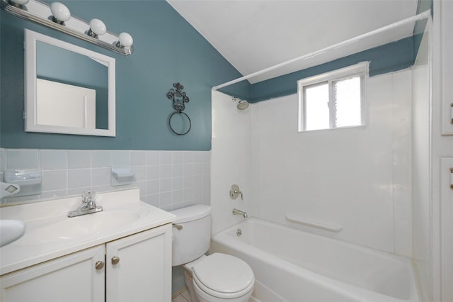 13 Cedar Ln, Poughkeepsie, NY 12601 - full bath featuring vanity, vaulted ceiling, shower / bathtub combination, tile walls, and a wainscoted wall
