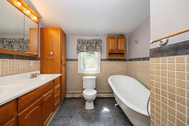 13 Cedar Ln, Poughkeepsie, NY 12601 - full bath with tile walls, a wainscoted wall, a freestanding tub, double vanity, and tile patterned flooring