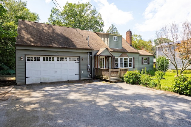 13 Cedar Ln, Poughkeepsie, NY 12601 - view of front of house featuring driveway, a chimney, a deck, an attached garage, and roof with shingles