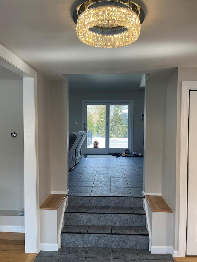 14 Cornfield Ln, Commack, NY 11725 - stairway with a chandelier, tile patterned floors, and baseboards