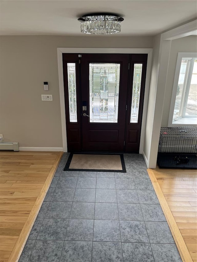 14 Cornfield Ln, Commack, NY 11725 - foyer with tile patterned floors, baseboards, and baseboard heating