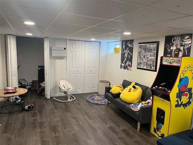 14 Cornfield Ln, Commack, NY 11725 - playroom with wood finished floors, a paneled ceiling, a wall unit AC, and recessed lighting