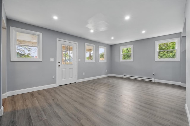 809 Broadway Unit 9W, Ulster Park, NY 12487 - spare room featuring a baseboard radiator, baseboards, recessed lighting, and wood finished floors