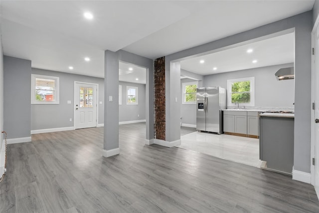 809 Broadway Unit 9W, Ulster Park, NY 12487 - unfurnished living room with a sink, recessed lighting, light wood finished floors, and baseboards
