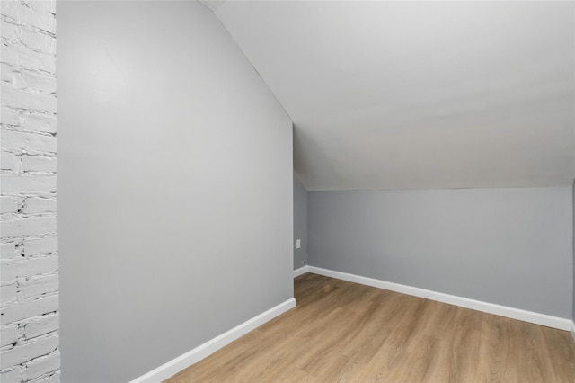 809 Broadway Unit 9W, Ulster Park, NY 12487 - bonus room featuring lofted ceiling, light wood-type flooring, and baseboards