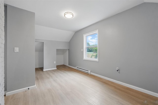 809 Broadway Unit 9W, Ulster Park, NY 12487 - additional living space featuring vaulted ceiling, a baseboard heating unit, light wood-style flooring, and baseboards