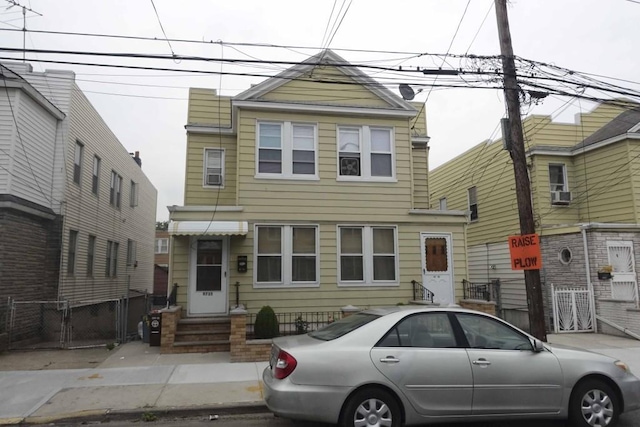 9735 77th St, Ozone Park, NY 11416 - view of property featuring a gate, fence, entry steps, and cooling unit