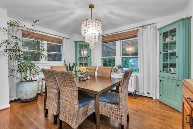 123 Maple Ave, Northport, NY 11768 - dining space featuring a chandelier, light wood-type flooring, and baseboard heating