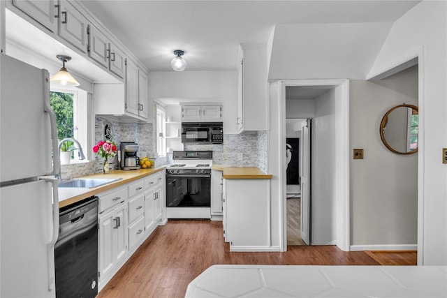 123 Maple Ave, Northport, NY 11768 - kitchen with black appliances, a sink, light countertops, and light wood-style flooring