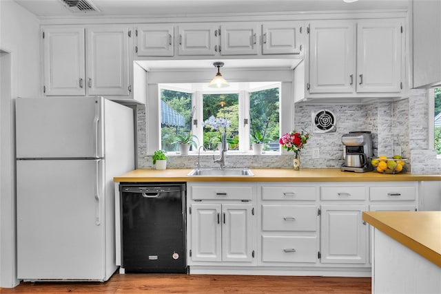 123 Maple Ave, Northport, NY 11768 - kitchen with dishwasher, freestanding refrigerator, light countertops, white cabinetry, and a sink