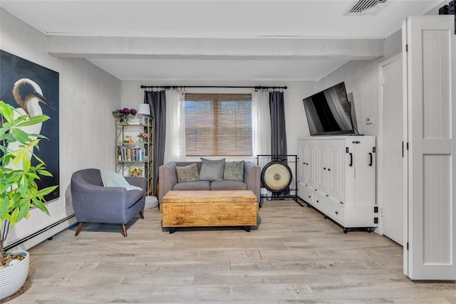 123 Maple Ave, Northport, NY 11768 - living room with a baseboard heating unit, light wood-style floors, and beamed ceiling